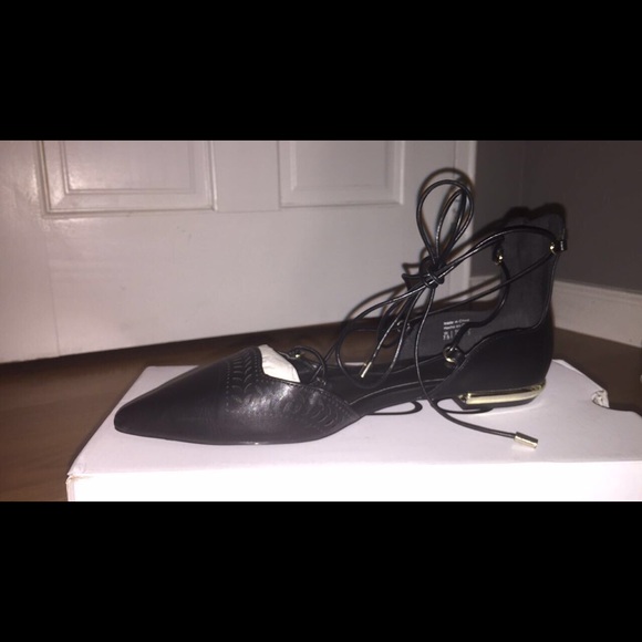 Black lace up shoes with gold accent heels