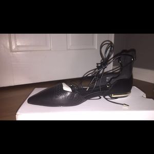 Black lace up shoes with gold accent heels