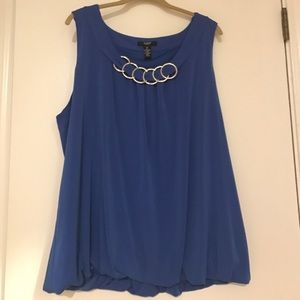 Blue blouse with silver circles at the neck.