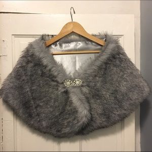 Faux fur wrap with jeweled clasps.