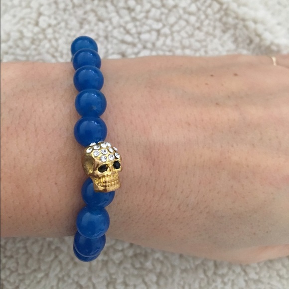Gold skull blue stone bracelet
