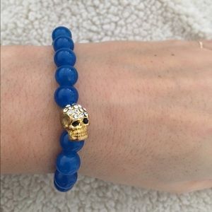 Gold skull blue stone bracelet