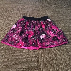 Hot pink skirt with floral lace overlay.