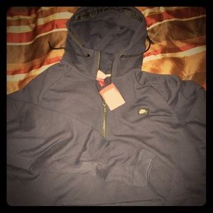 NEW. Men's Nike pullover hoodie with a half zip.
