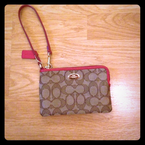 Brown coach wristlet with red leather trim