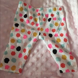 White pants with multicolored dots.