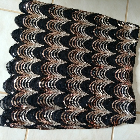 Black and gold sequin scalloped mini skirt.
