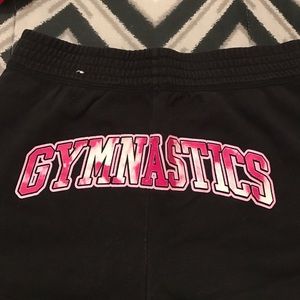 Black and pink "Gymnastics" shorts
