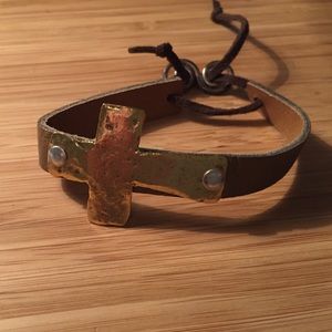 Metal cross bracelet on leather band