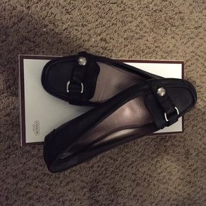 Coach flats, black in color.