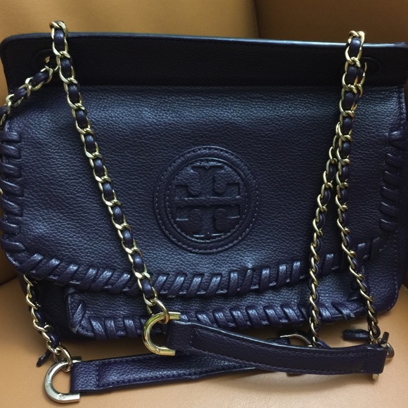 Tory Burch leather bag .hold by someone