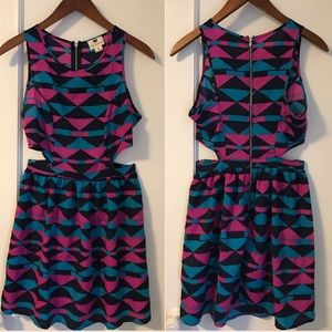 Geometric patterned dress with side cut-outs.