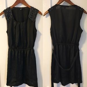 Black tunic dress with embellishment.