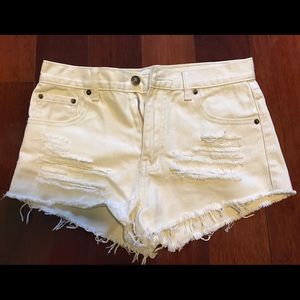 Cream distressed shorts.