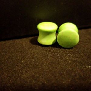 Flared green stone plugs