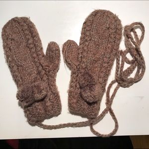 Brown knit mittens with poms
