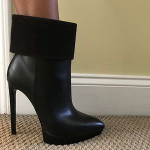 Saint Laurent pointed toe black leather booties.