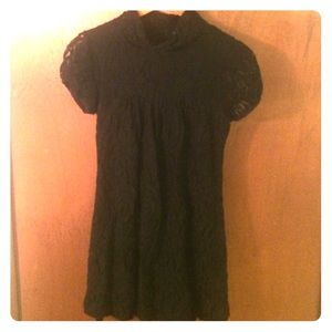 Black lace dress, capped sleeves and turtle neck.