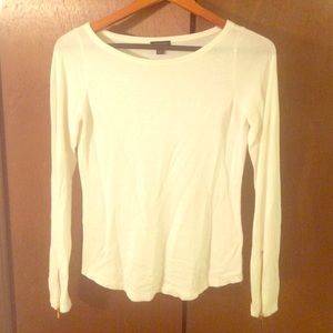 Cream sweater with gold zipper on sleeve