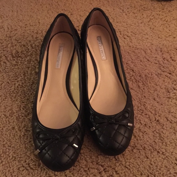 Black quilted leather wedge pumps.