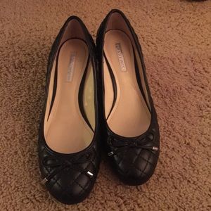 Black quilted leather wedge pumps.