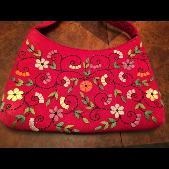Red handbag with colorful embroidered flowers