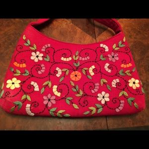 Red handbag with colorful embroidered flowers