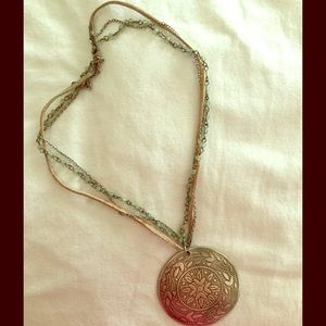 Jade colored beads, leather and large emblem