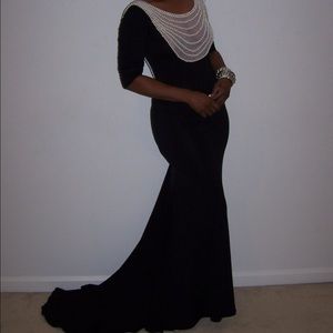 Black gown with pearls in the front and back.