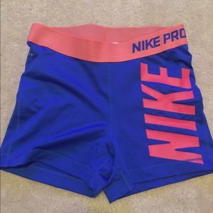 Blue and pinkish orange Nike Pro shorts