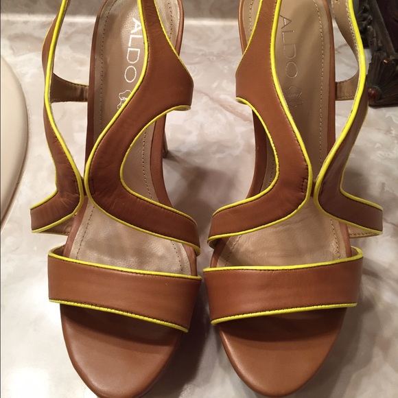Neon yellow trim on beige leather platform heels.