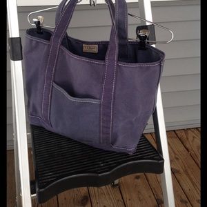 Small navy blue tote bag with front pocket