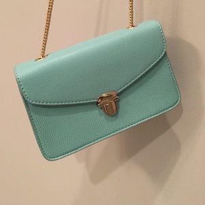 Teal, gold chained purse. Never used!