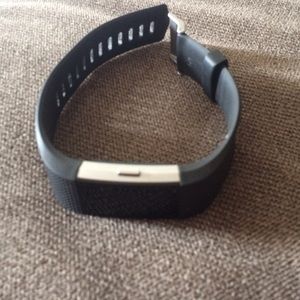 Fitbit Charge 2 with charging cord.