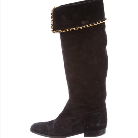 Black suede Chanel boots with gold chain at folds.