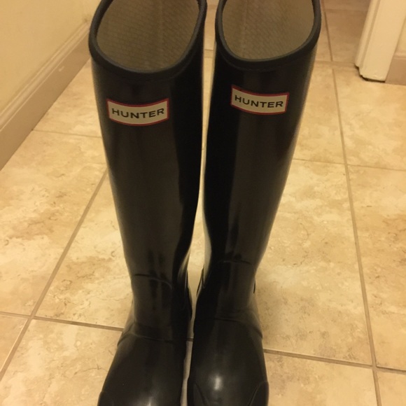 Tall black glossy hunter boots