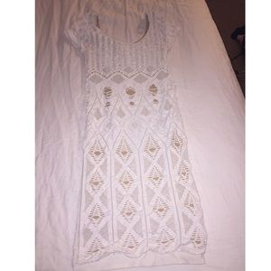 Bebe form fitting dress with tan background