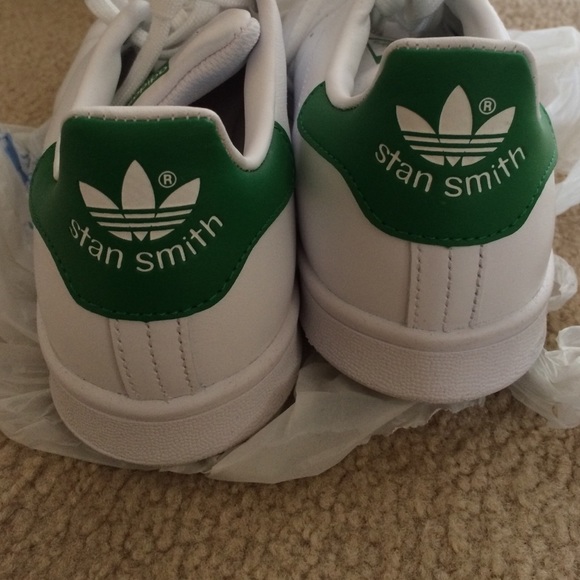 Adidas Stan Smith green and white shoes.
