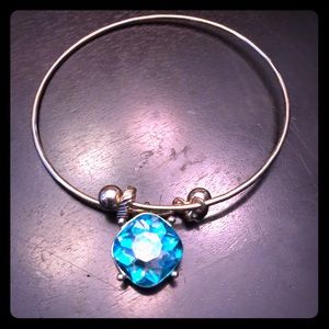Gold bangle bracelet with teal stone