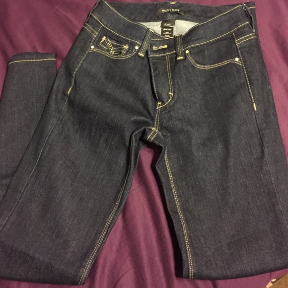 Unworn "slim leg" dark blue jeans
