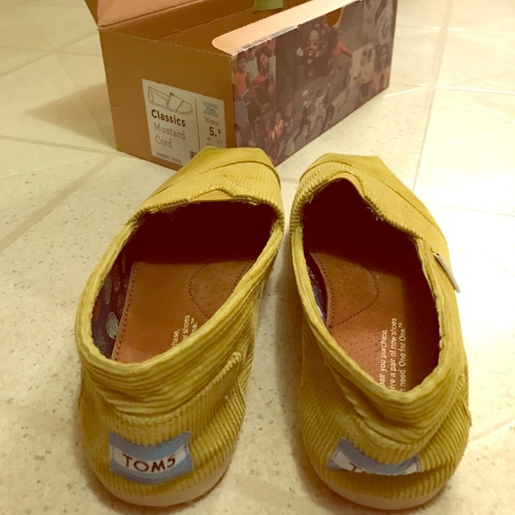 TOMS mustard yellow slip on's