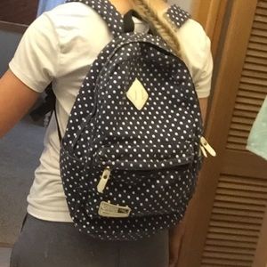 Navy blue and white polka dot backpack
