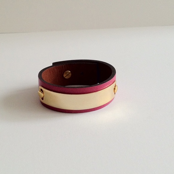 Leather bracelet with Gold tone metal tag.
