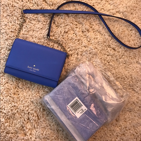 Blue Kate spade purse in package.