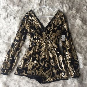 Never worn black and gold long sleeved bodysuit