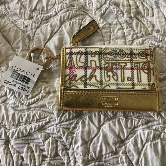 Coach creme/gold coin purse w/ keychain holder.