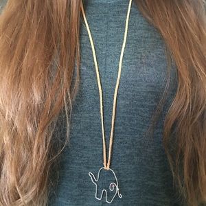 Hand crafted wire elephant with bead on tan suede