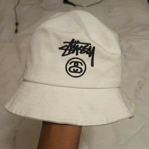 White Stussy bucket hat.