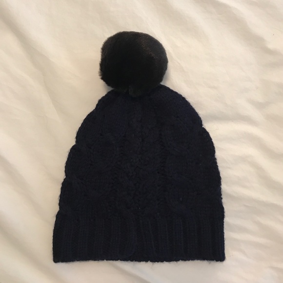 Navy knit hat with black fuzzy pompom