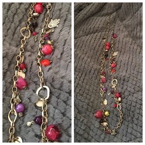 Gold tone charm and multicolored bead necklace.